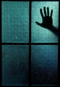 2489184-580063-silhouette-of-a-hand-behind-a-window-or-glass-door-symbolizing-horror-or-fear